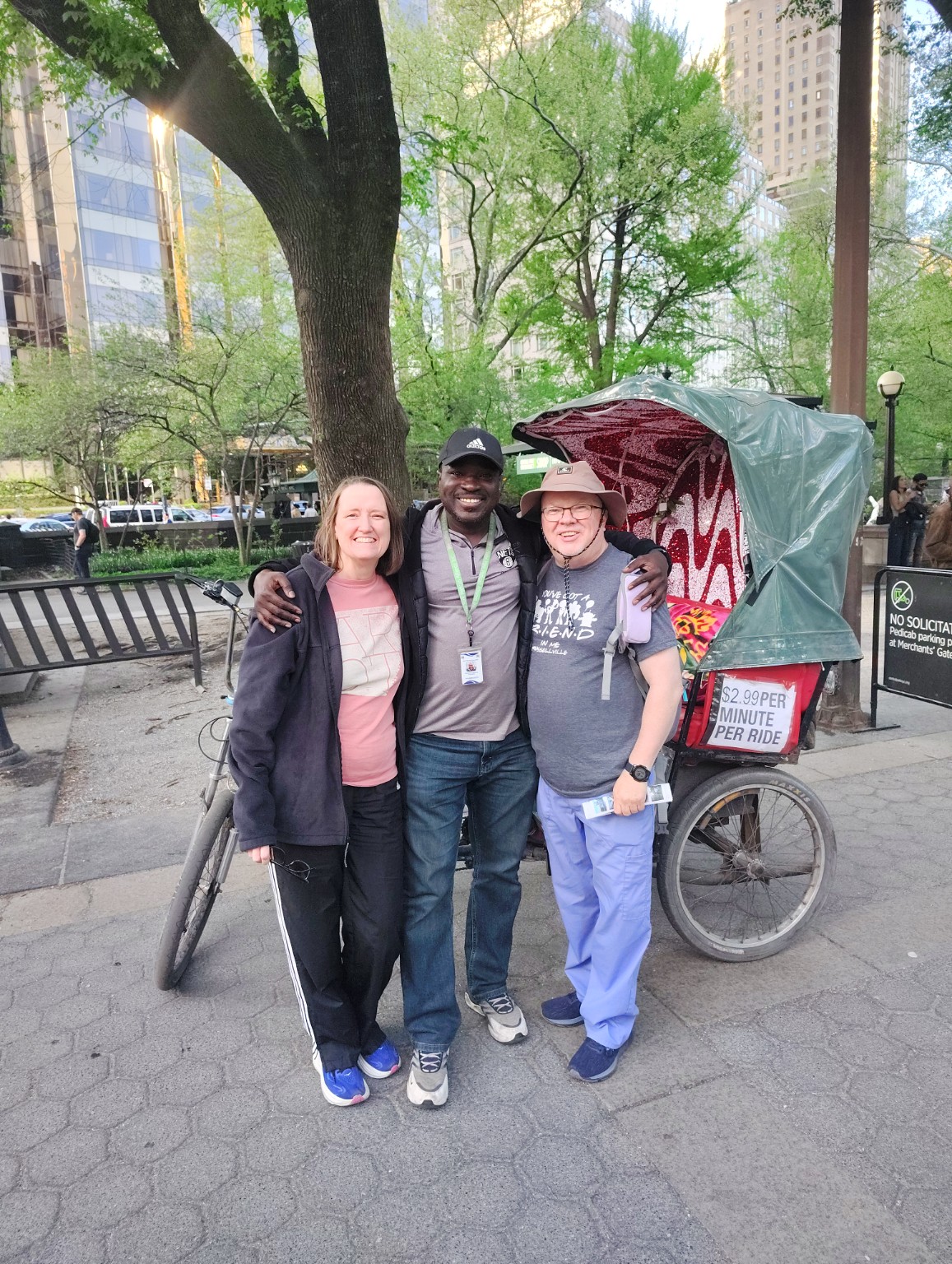 Pedicab guide with happy guests beside a decorated pedicab